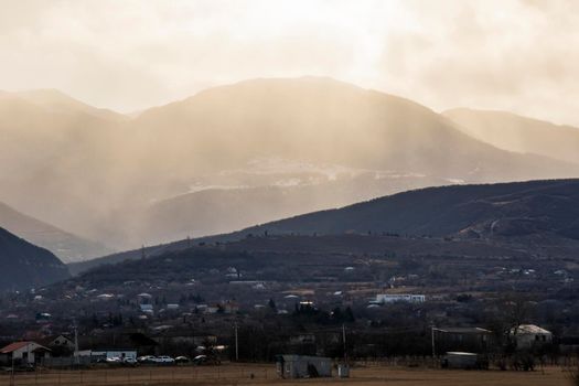 Mountain and town landscape during sunset in Kaspi, Georgia