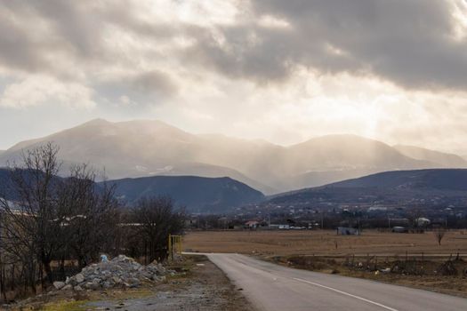 Mountain and town landscape during sunset in Kaspi, Georgia