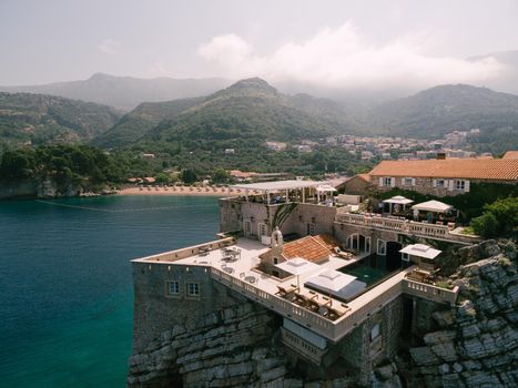 Aerial view of the terraces and pool on the roof of an ancient building on the island of Sveti Stefan. High quality photo