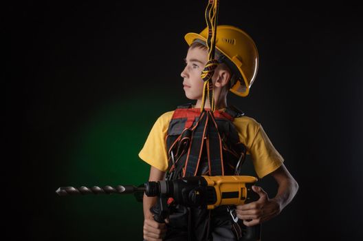 the child the Builder costume posing with a work tool