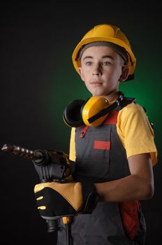 the child the Builder costume posing with a work tool