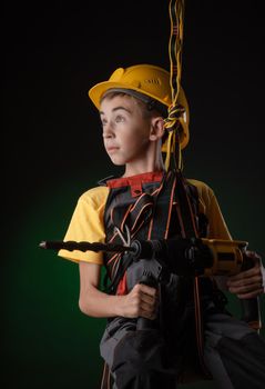 the child the Builder costume posing with a work tool