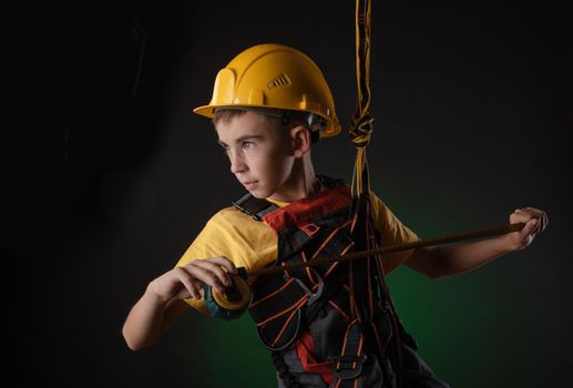 the child the Builder costume posing with a work tool