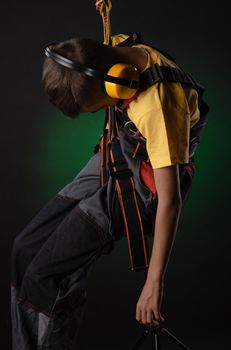 the child the Builder costume posing with a work tool