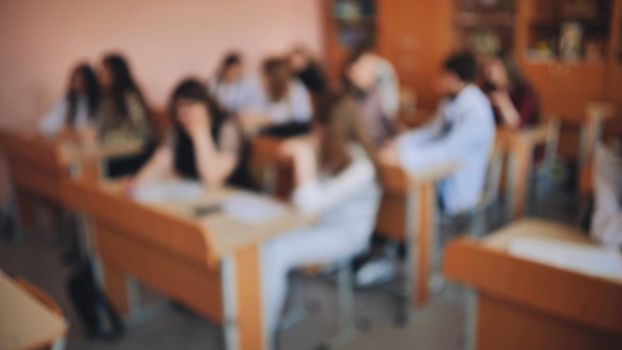 Pupils of the 11th grade in the class at the desks during the lesson. Russian school