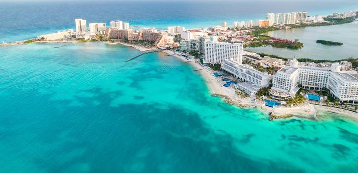 Aerial panoramic view of Cancun city hotel zone in Mexico. Caribbean coast landscape of Mexican resort with beach Playa Caracol and Kukulcan road. Riviera Maya in Quintana roo region on Yucatan Peninsula