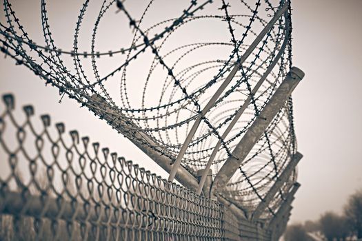 Restricted area barbed fence. Barrier border. Boundary security wall.