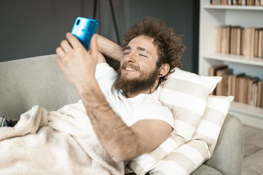 Single man makes selfie for dating site. Lonely guy wants to meet women online for real relationships. Close-up. High quality photo