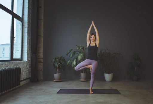 Body conscious. Human body, physical position, well being concept. Yoga, young woman stands in an asana. High quality photo