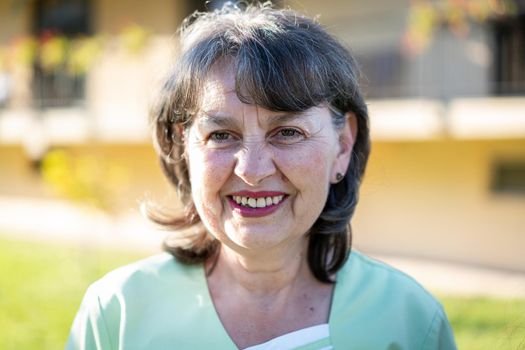 Portrait of the nurse with green uniform outdoors