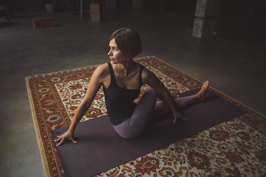 Yogi Female Practicing Yoga Pose on Mat in Vintage Living Room, Paripurna Navasana Exercise, Sport Workout Style, Fitness at Home, Healthy Lifestyle. Close-up. High quality photo