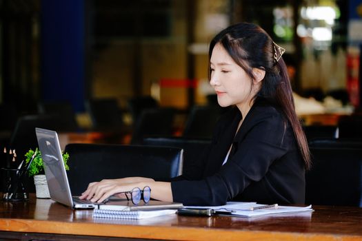 The concept of a business woman using a computer to check financial statements and investments via the Internet