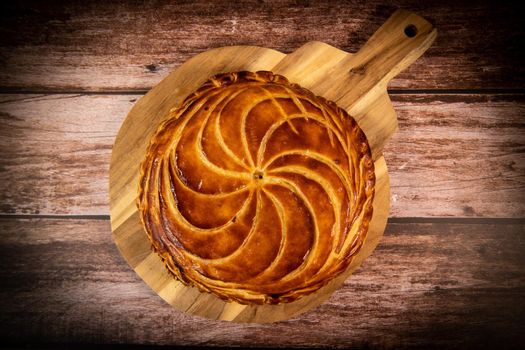 Galette des rois on wooden table, Traditional Epiphany cake in France. High quality photo