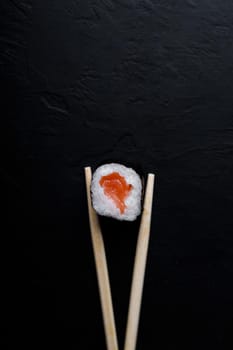 Sushi with tuna salmon rice and chopsticks on an isolated background.