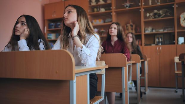 Pupils of the 11th grade in the class at the desks during the lesson. Russian school