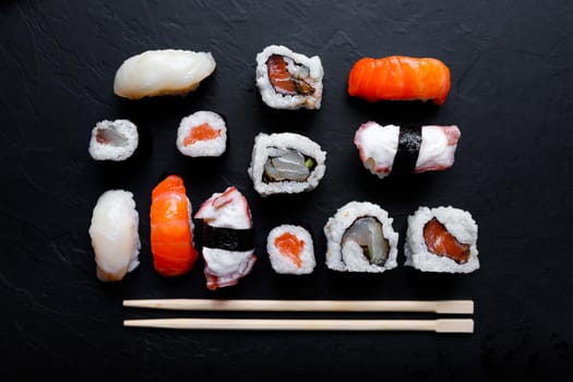 japanese sushi food. Maki ands rolls with tuna, salmon, shrimp, crab and avocado. Top view of assorted sushi