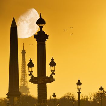 Eiffel Tower and Place de la Concorde and big moon in yellow sky, Paris, France