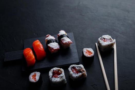 japanese sushi food. Maki ands rolls with tuna, salmon, shrimp, crab and avocado. Top view of assorted sushi