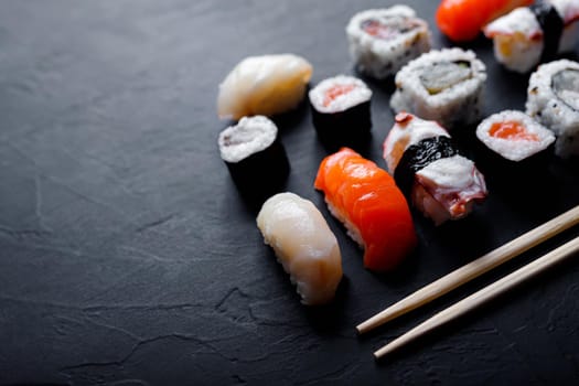 japanese sushi food. Maki ands rolls with tuna, salmon, shrimp, crab and avocado. Top view of assorted sushi