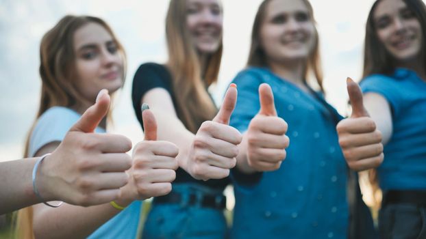 A group of girls girlfriends show thumbs up