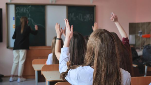 High school students stretch their hands in the lesson. Russian school