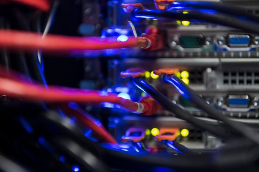 network server room closeup on fiber optic hub or switch for digital communications and internet in mainframe corporate business data center supercomputer. High quality photo