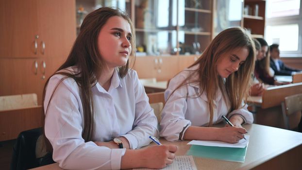 Pupils of the 11th grade in the class at the desks during the lesson. Russian school