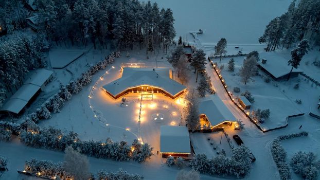 Village house illumination in winter from drone. High quality photo