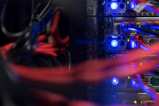 network server room closeup on fiber optic hub or switch for digital communications and internet in mainframe corporate business data center supercomputer. High quality photo