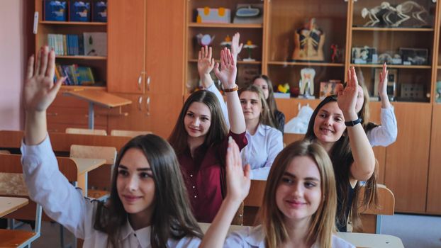 High school students stretch their hands in the lesson. Russian school