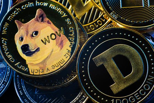 Horizontal view of cryptocurrency tokens, including Bitcoin, dogecoin, and ethererum seen from above on a black background. High quality photo