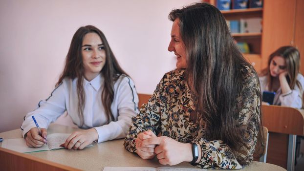 Pupils of the 11th grade in the class at the desks during the lesson. Russian school