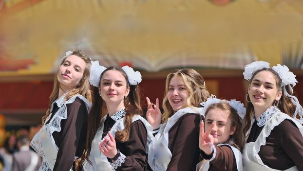 Happy Russian female graduates pose on their graduation day