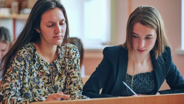 Pupils of the 11th grade in the class at the desks during the lesson. Russian school