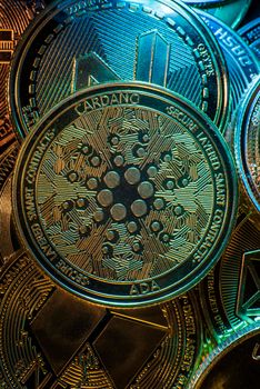 Horizontal view of cryptocurrency tokens, including Cardano, ADA, Bitcoin, dogecoin, and Ethereum seen from above on a black background. High quality photo