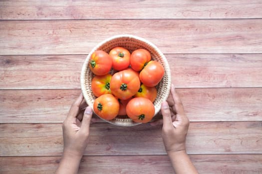 Hand Of Person Picking Tomatoes from a Bowl .