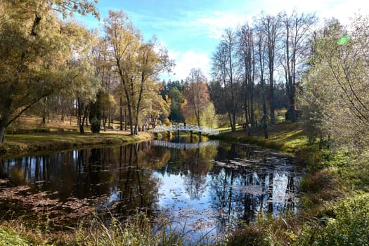 Small white bridge over river. High quality photo