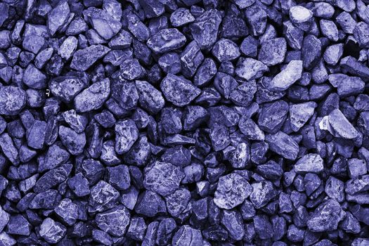 Lots of wet rocks. Pebble background. Lots of purple gems. Modern luxury background or layout with space for text. Color 2022 is very peri year.