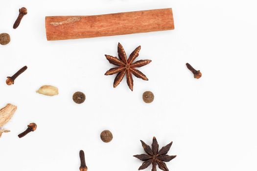 Mulled wine set. A set of spices for mulled wine on a white background. Raisins, ginger, cinnamon, star anise, cardamom, cloves top view on a white background. Hot medicinal drink. Winter cocktail.