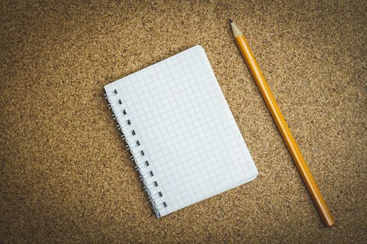 Notepad and pencil. Notes in a notebook. Template for records. Reminder note. Poems in notebook. Blank notebook and pen on a dark background. Wood texture.