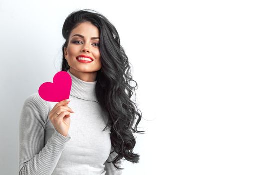 Valentines Day. Woman holding Valentine day heart card sign with copy space on white background.