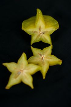 Exotic starfruit or averrhoa carambola on wooden cut board. Healthy food, fresh organic star apple fruit