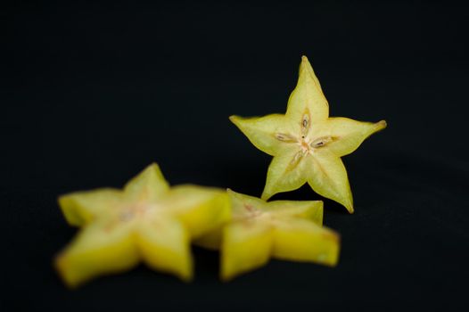 Exotic starfruit or averrhoa carambola on wooden cut board. Healthy food, fresh organic star apple fruit