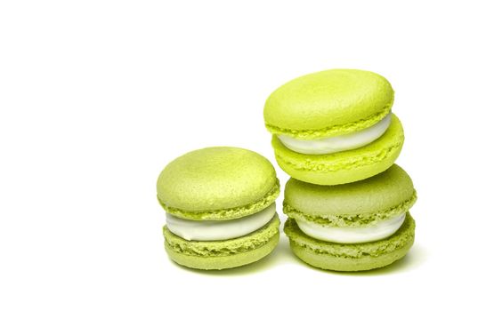 Banner of colorful macaroons isolated on white background. Lemon and green french cookies. Caramel hazelnut and strawberry cakes in front view. Bakery concept with blank space