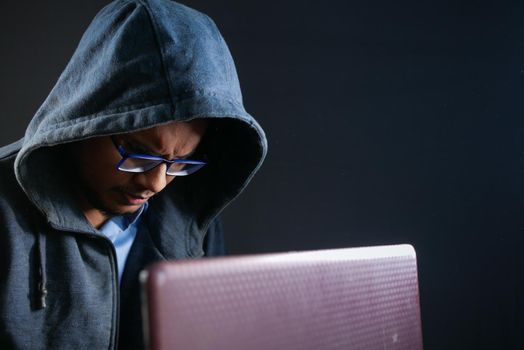 hacker hand stealing data from laptop top down.