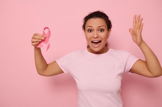 October Breast Cancer Awareness month, Woman in pink T- shirt with Pink Ribbon for supporting people living and illness. Woman in pink t-shirt holding cancer awareness pink ribbon