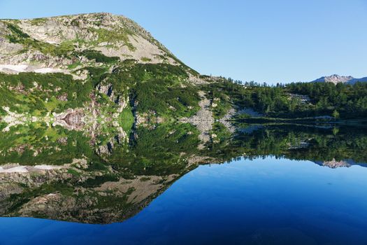 reflection of the mountain on water, mirror image of mountains in water Location: Siberia, the Golden Valley