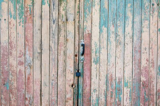 Fragment of the old and dilapidated doors. Wooden vertical texture of turquoise Colors, shabby wooden surface. Old texture for antique background Old texture for antique background