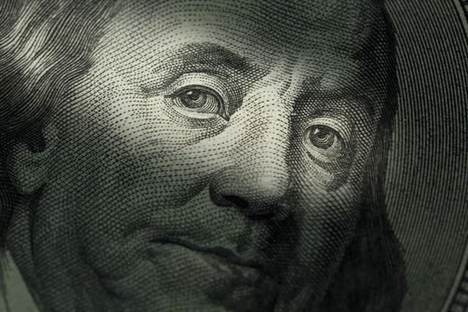 Hundred dollars bill - Benjamin Franklin. Selective focus face