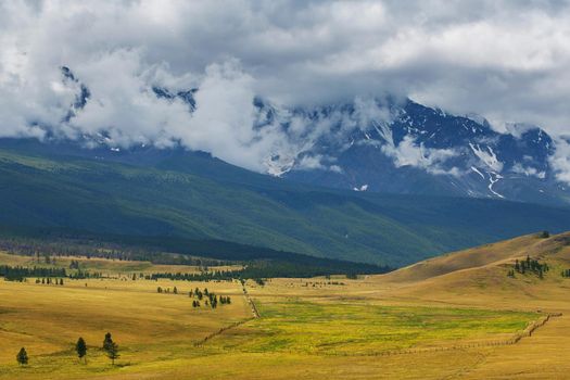 Scenic view of the snow-covered North-Chuya range in the Altai mountains in the summer, Siberia, Russia.